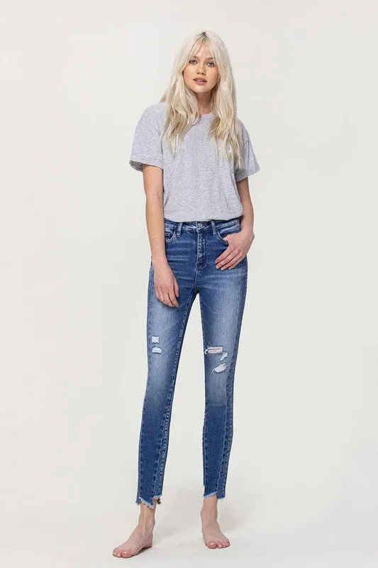 HIGH RISE ANKLE SKINNY WITH UNEVEN HEM DETAIL